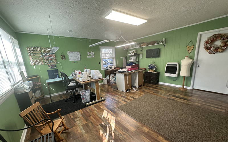 A room with a mannequin and sewing machines
