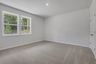 bedroom with windows and carpet