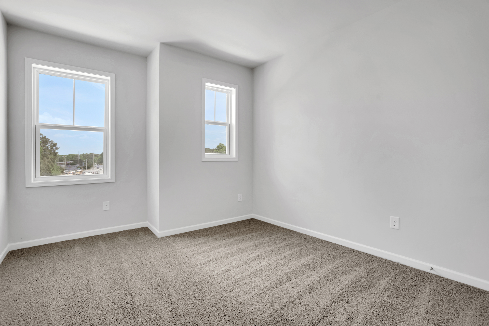 bedroom with windows and carpet
