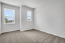 bedroom with windows and carpet
