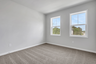 bedroom with windows and carpet