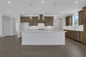 kitchen with wood-finish cabinets and quartz counters