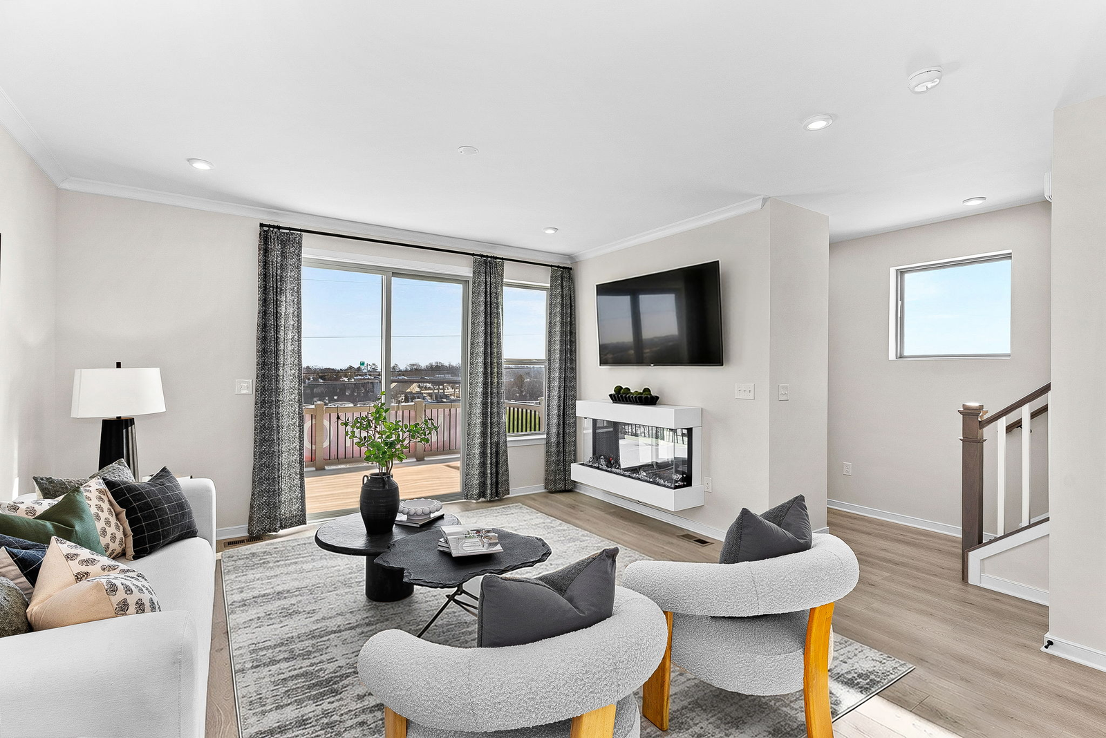 sofa with hardwood floors and carpet, fireplace, sofa, and tv