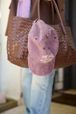 purple hat and brown bag