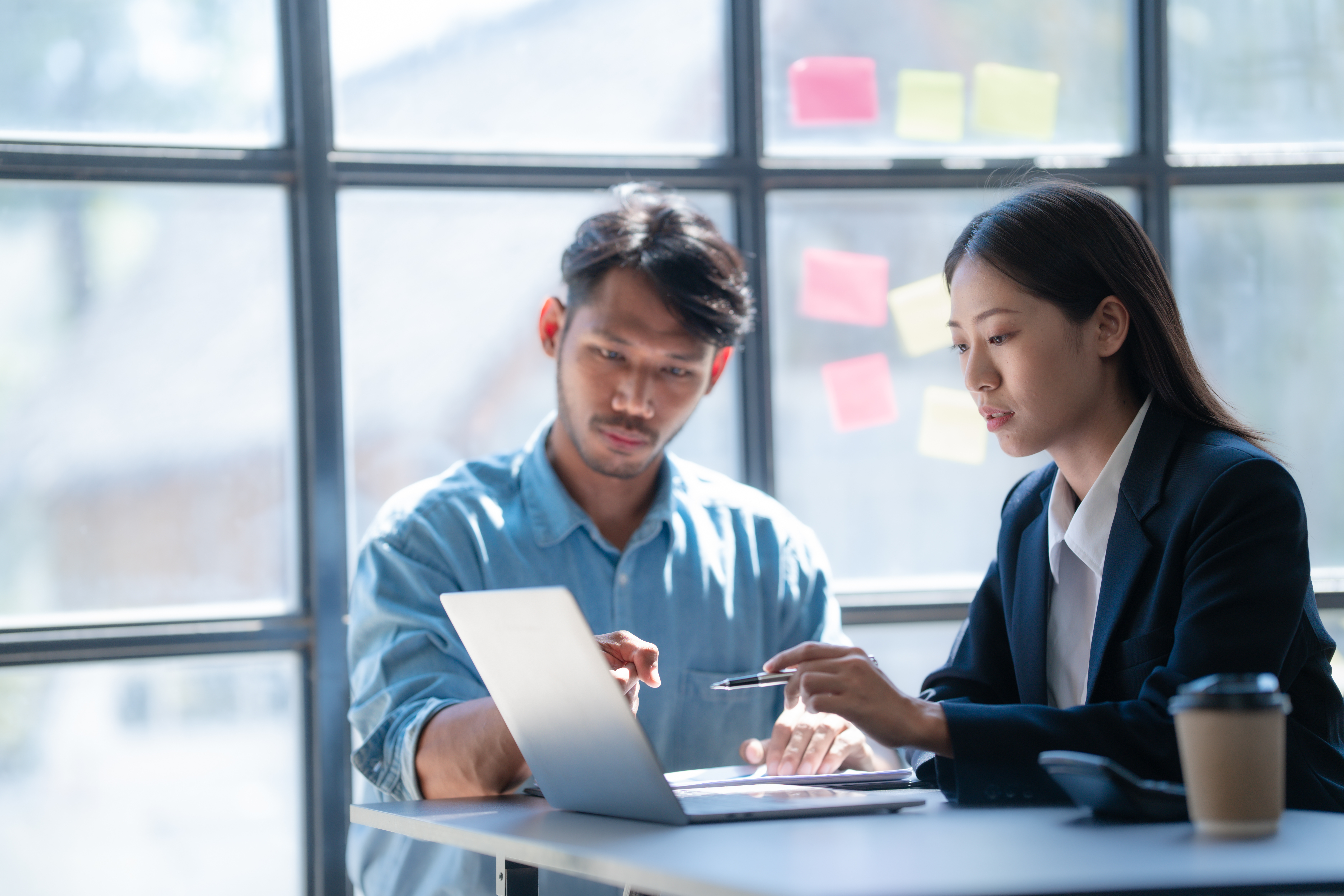 Two persons looking at a computer.