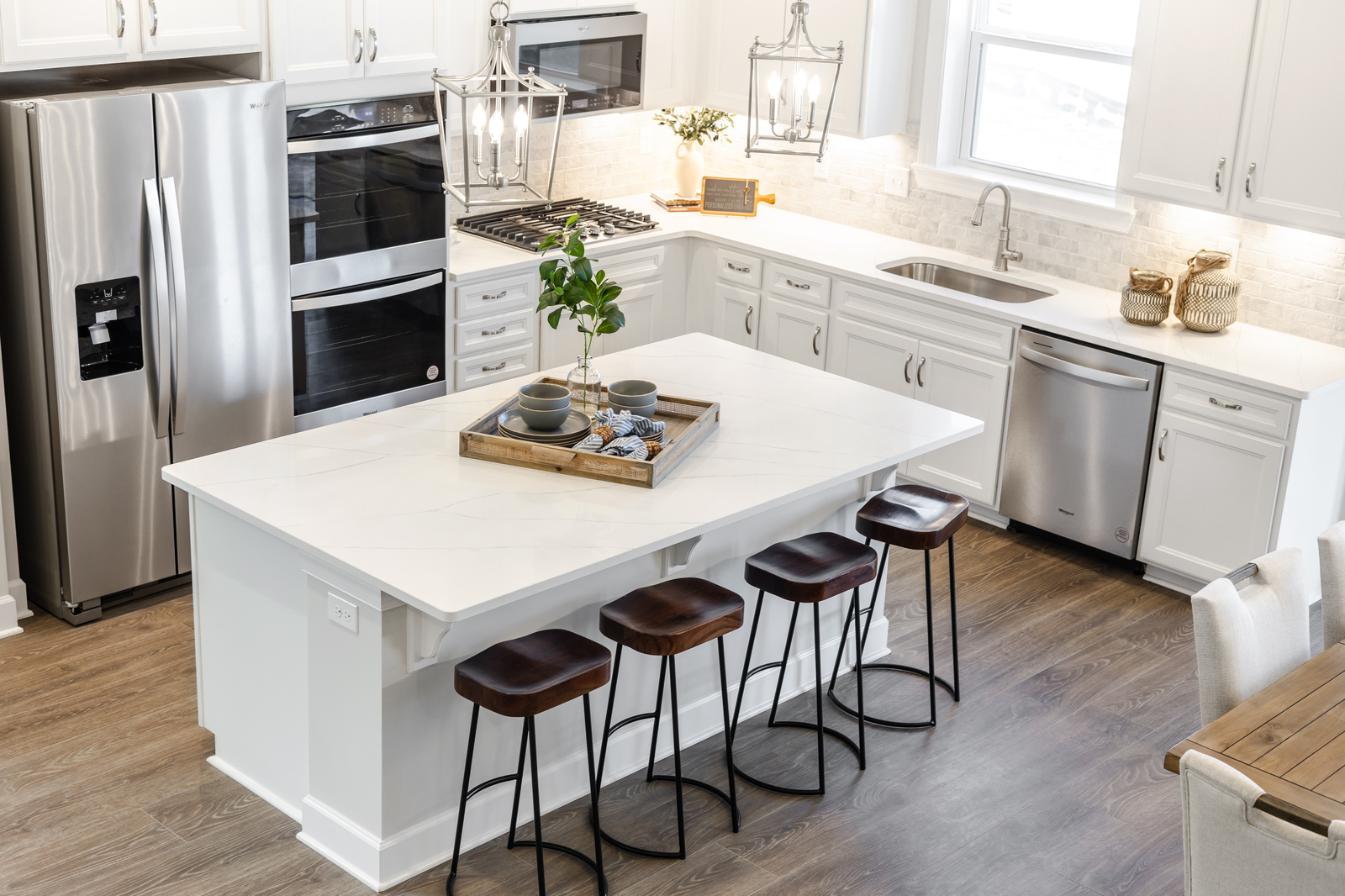 kitchen with white countertops, white cabinets, stainless steel appliances and hardwood floors