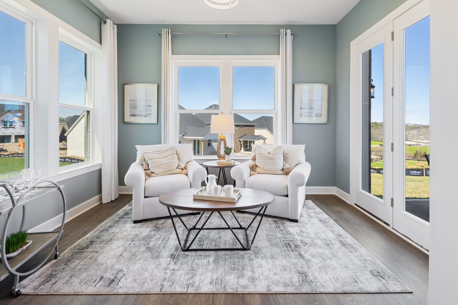 study with wood floors and large windows