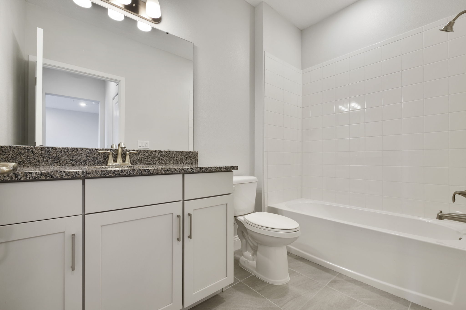 single sink vanity with water closet and shower