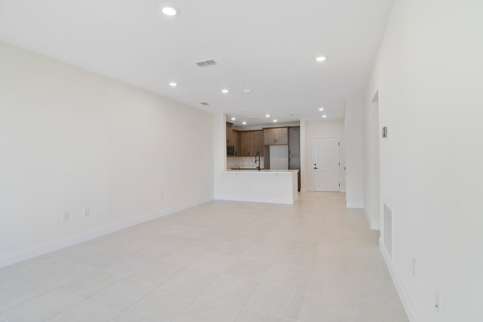 great room with tile flooring and sliding door leading to balcony
