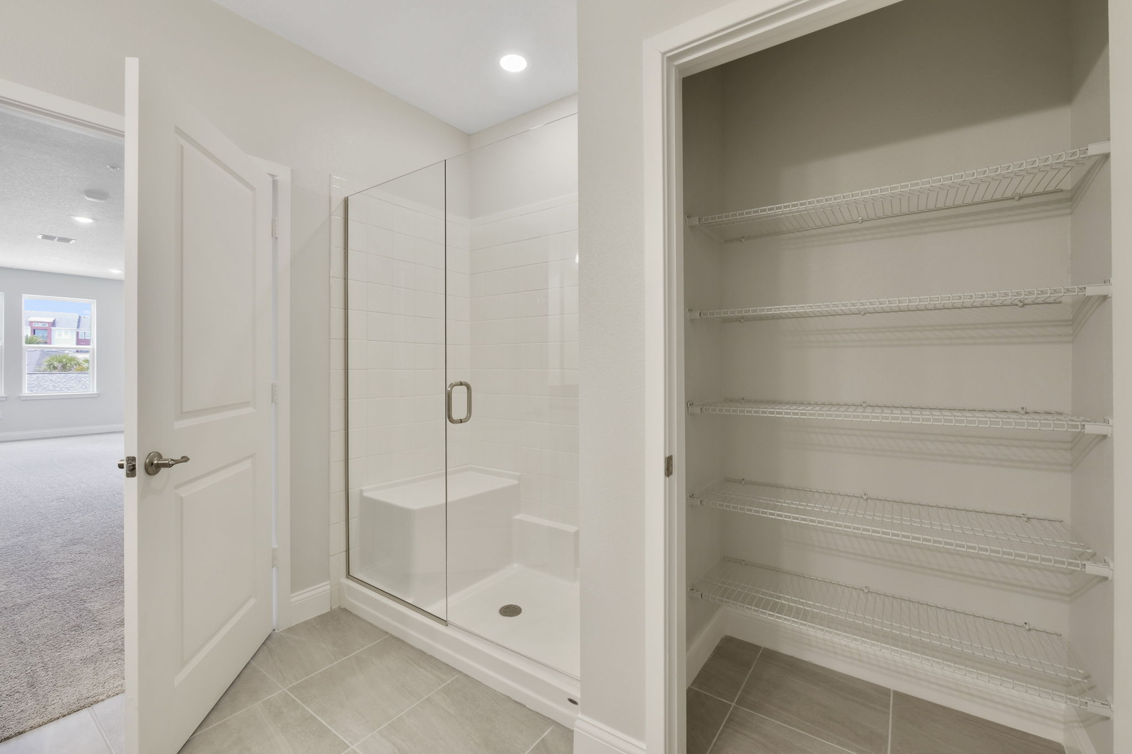 dual sink vanity with large mirror, water closet and shower