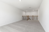 upstairs loft with large windows and carpet