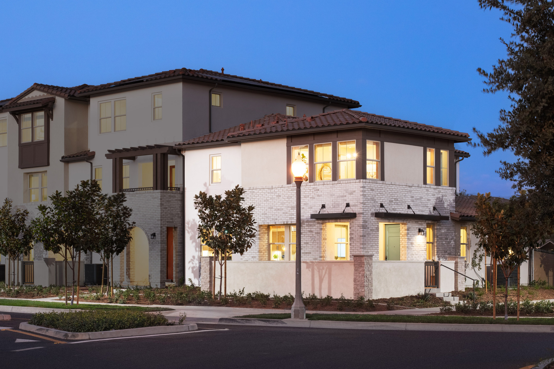 exterior of two-story townhome with front patio and neutral paint