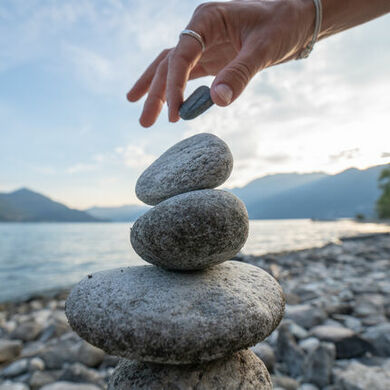Balance concept person stacking rocks