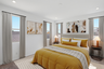 spacious bedroom with a king-sized bed with yellow bed covers, a white rug, and white accent pillows
