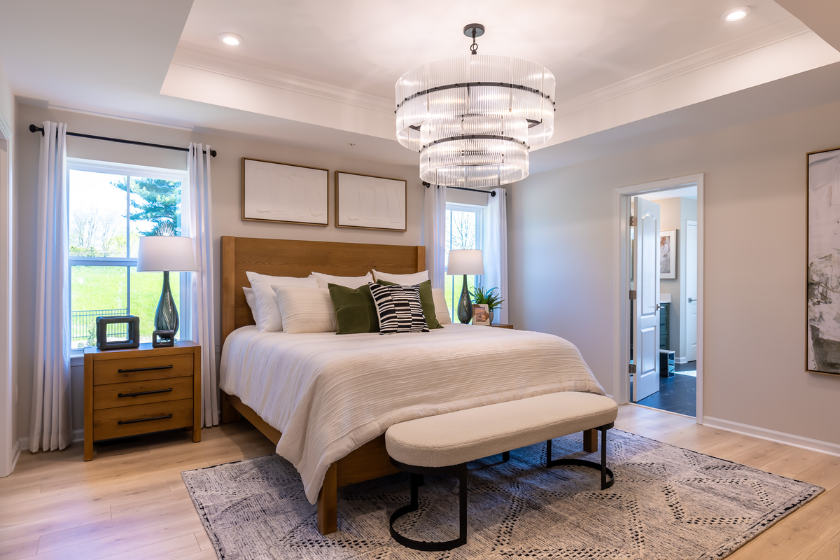 primary suite with a box ceiling & designer floors