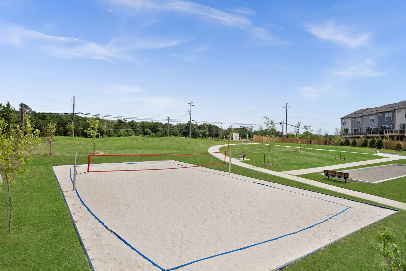beach volleyball net with grass surounding it