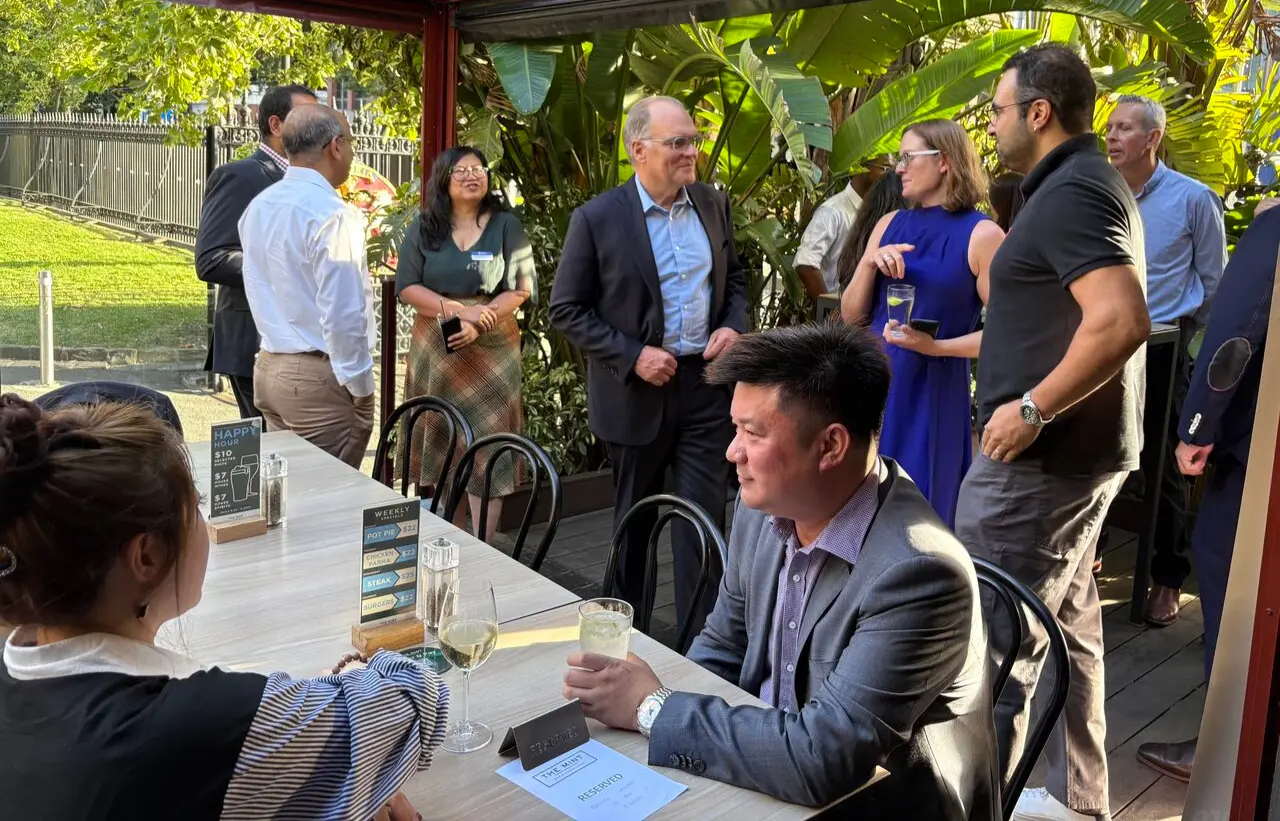 Ben Farrell, CIPS CEO, mingles with CIPS members from the Asia Pacific region, in a garden.