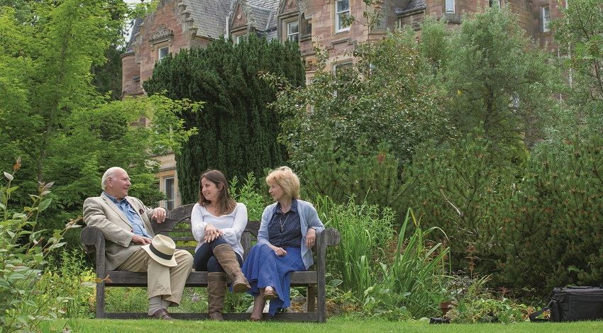 Sir John sits with his family with the Aigas Field Centre in the background