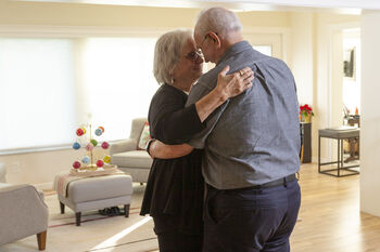 Bob and Karen Snedeker dancing in their living room