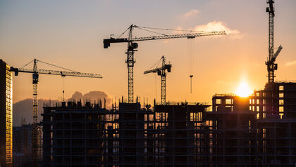 Building cranes at sunset