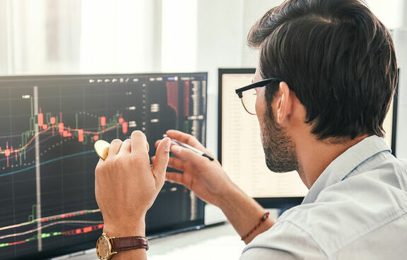 Man mining cryptocurrency at computer