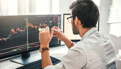 Man mining cryptocurrency at computer