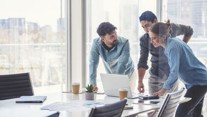 Business professionals having casual meeting over laptop