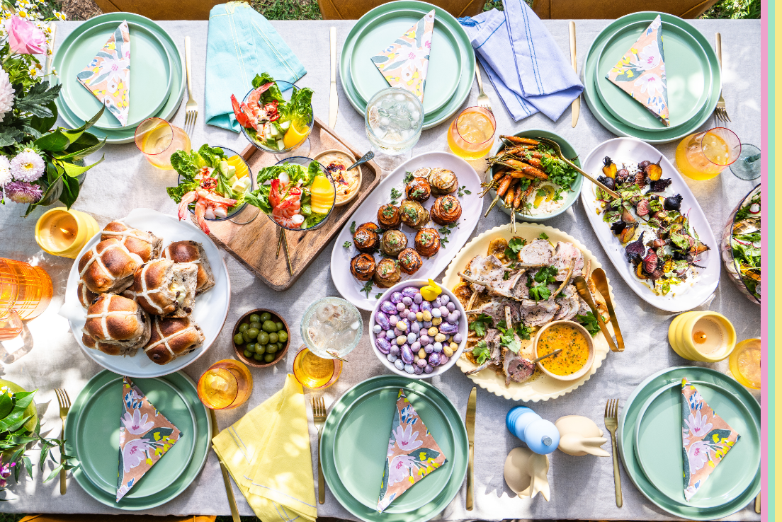 Table scape featuring Easter decor, food and easter eggs