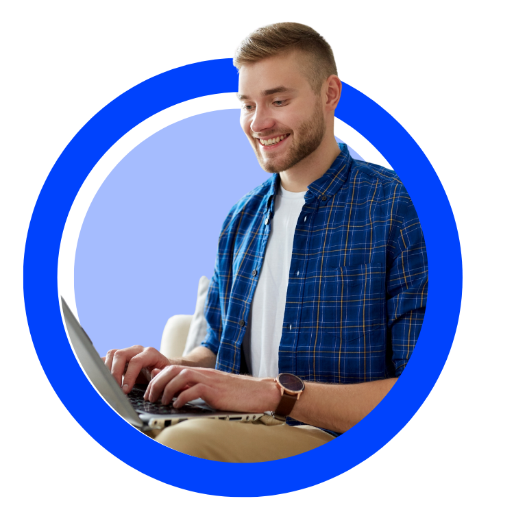 Smiling young man working on laptop