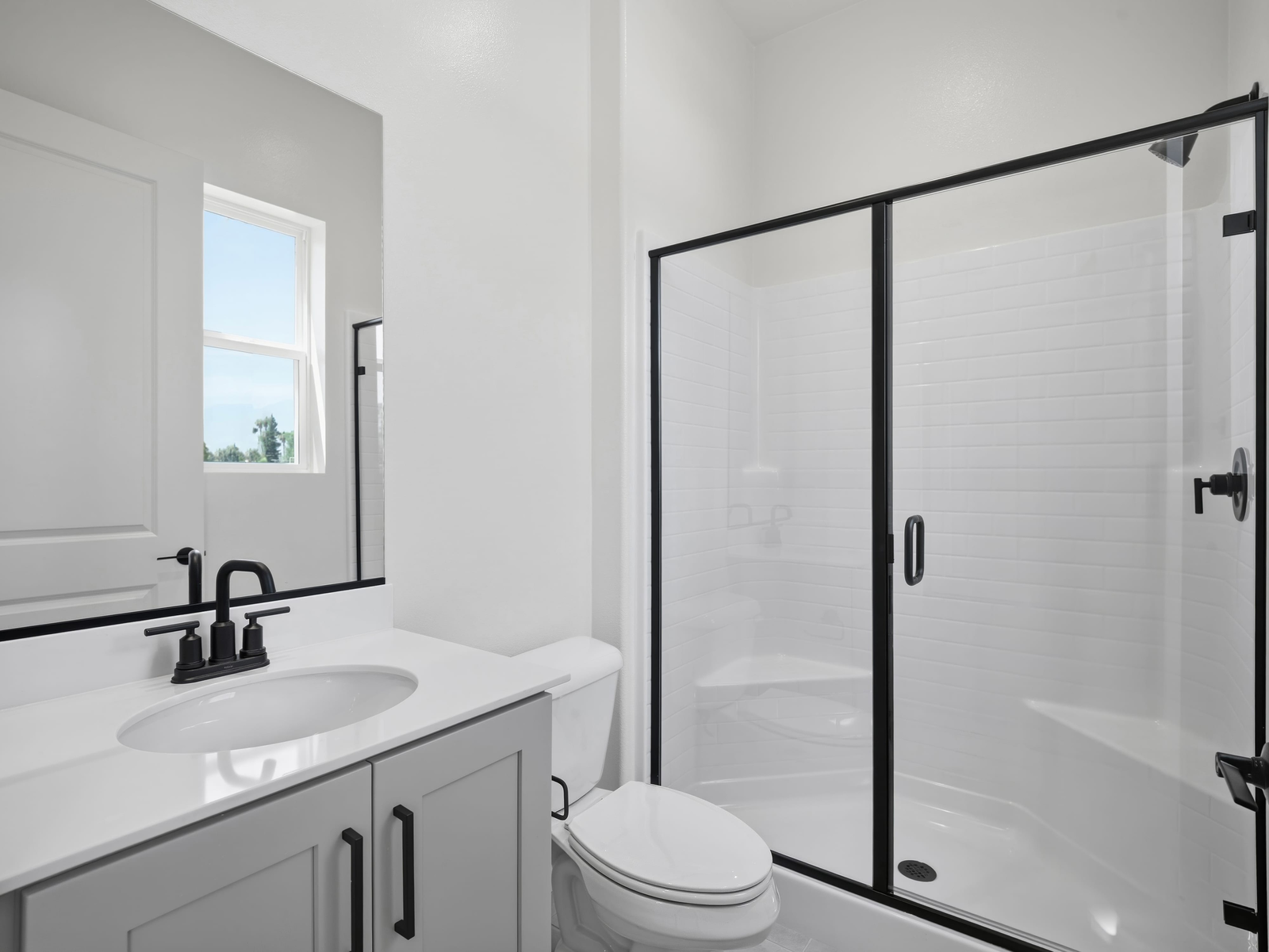 bathroom with black hardware and white countertops
