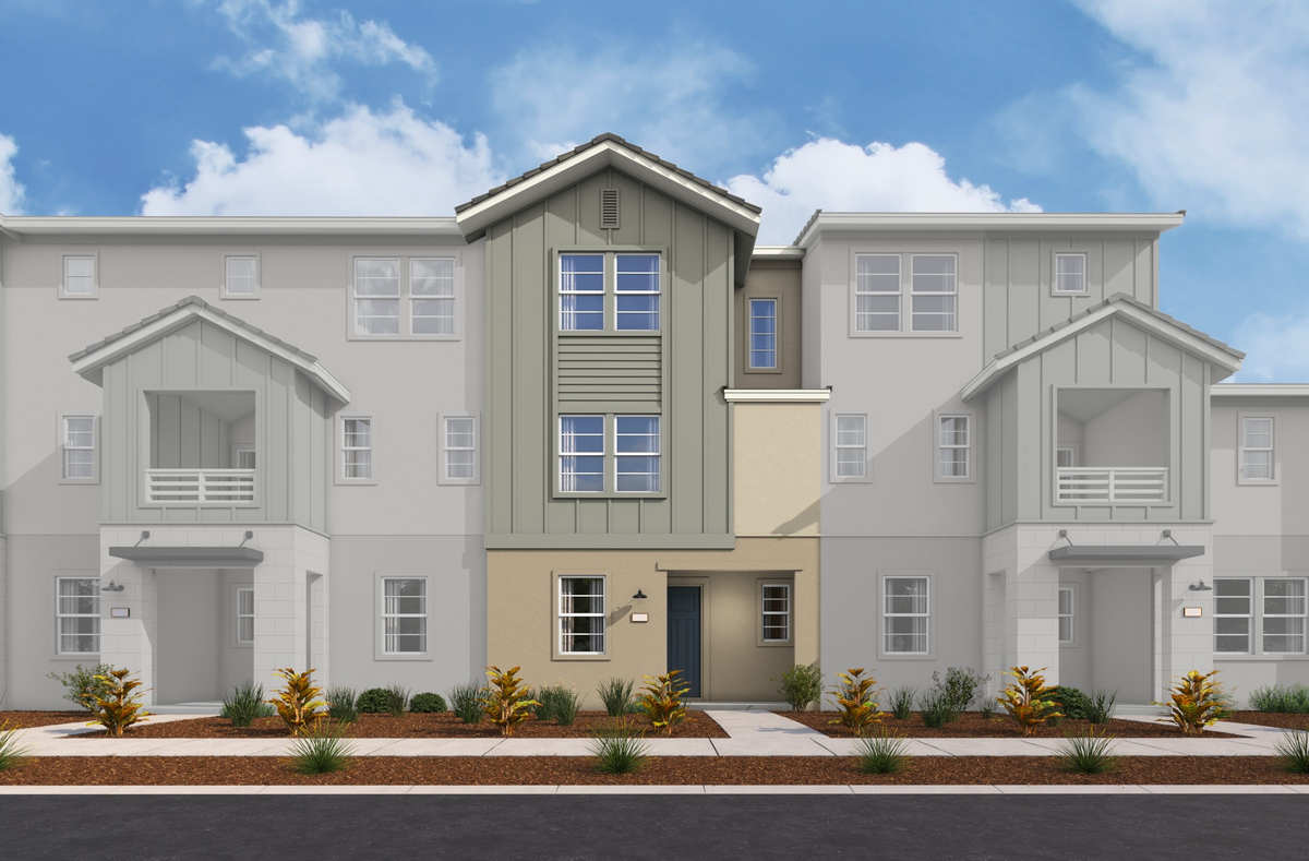 exterior of three-story townhome with neutral paint and large windows