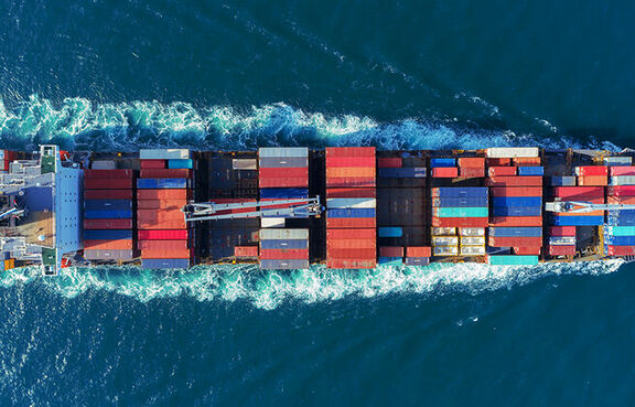 Top down look at loaded cargo ship moving through water