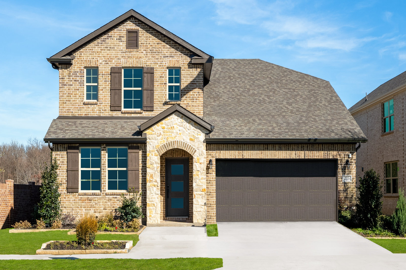 stone and brick exterior with shutters on windows