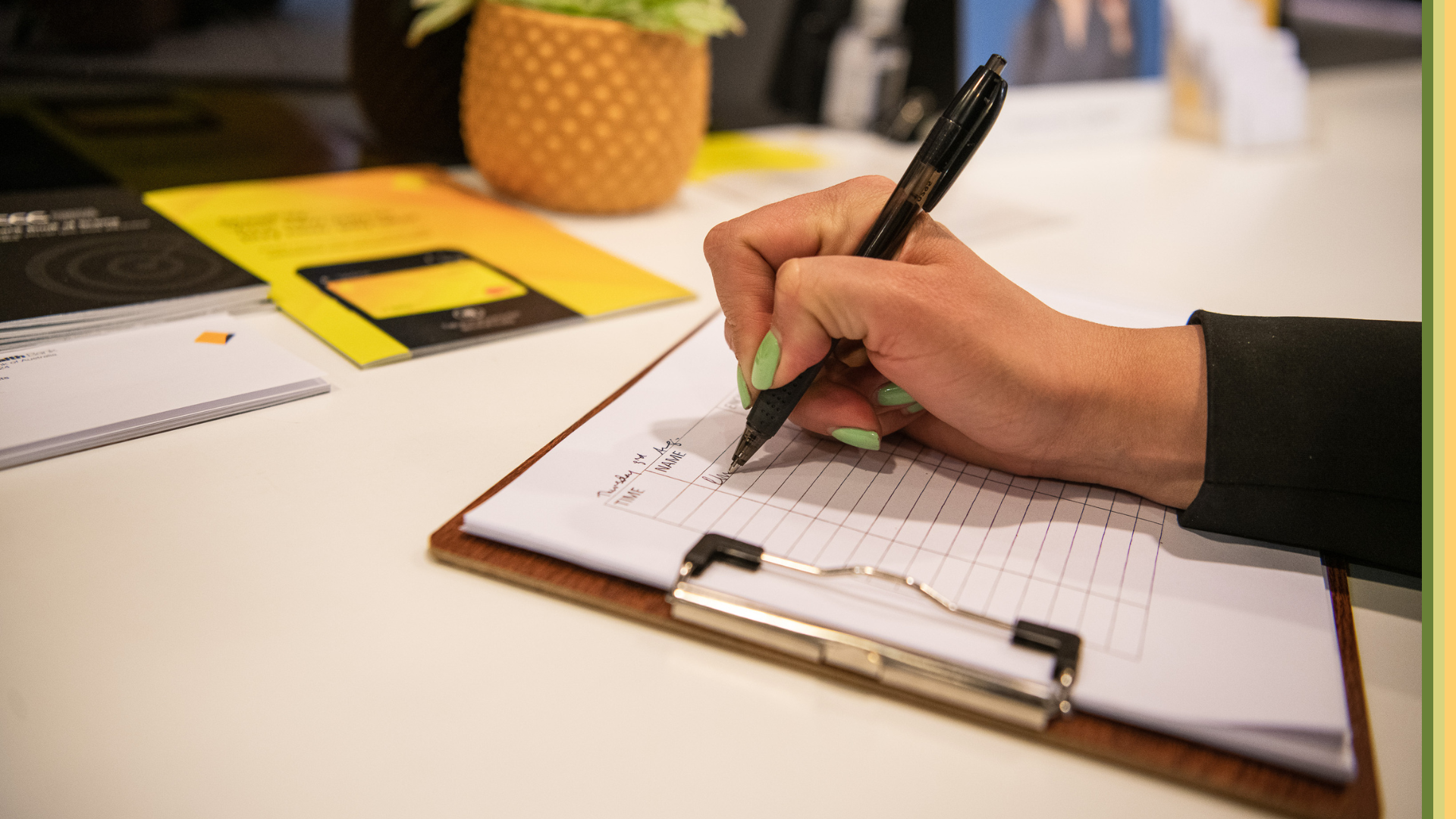 Commonwealth Bank staff member filling out forms