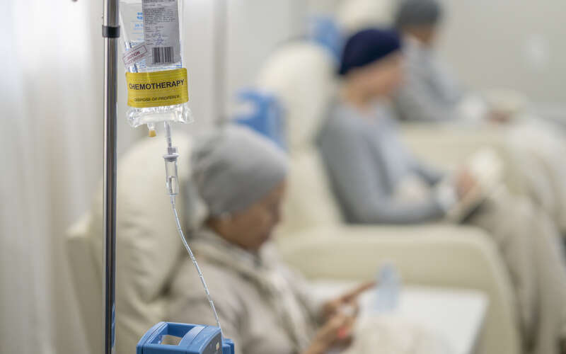 Photo of several patients in chemotherapy chairs receiving treatment
