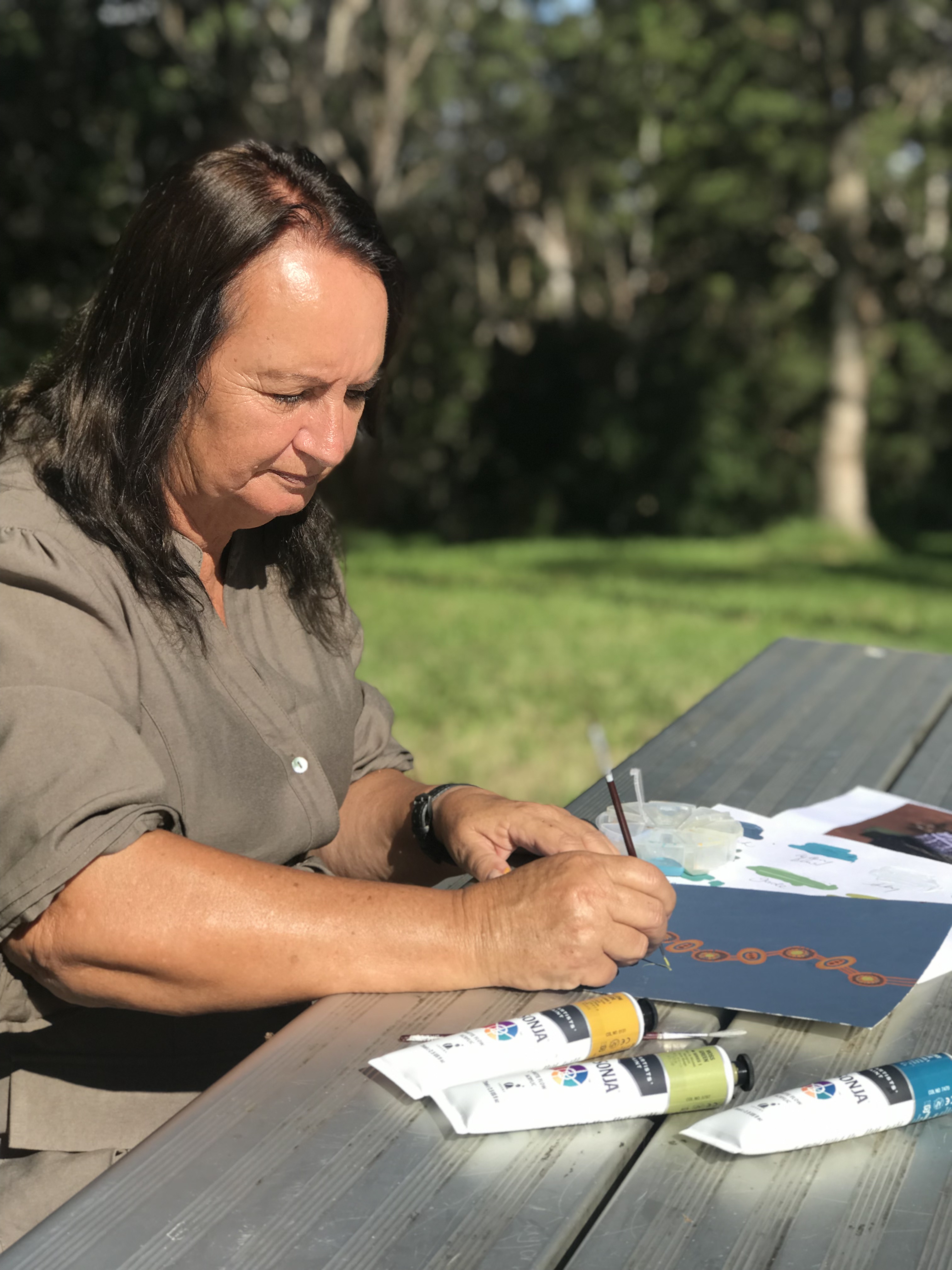 Indigenous artist creating artwork 