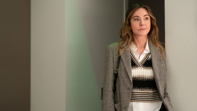Christa Miller as Liz standing in a hallway in Shrinking.jpg