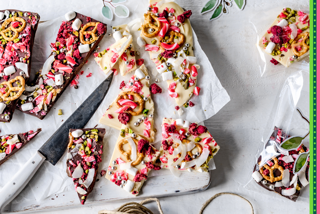Christmas chocolate bark broken up on a platter, plus some packaged in cellophane