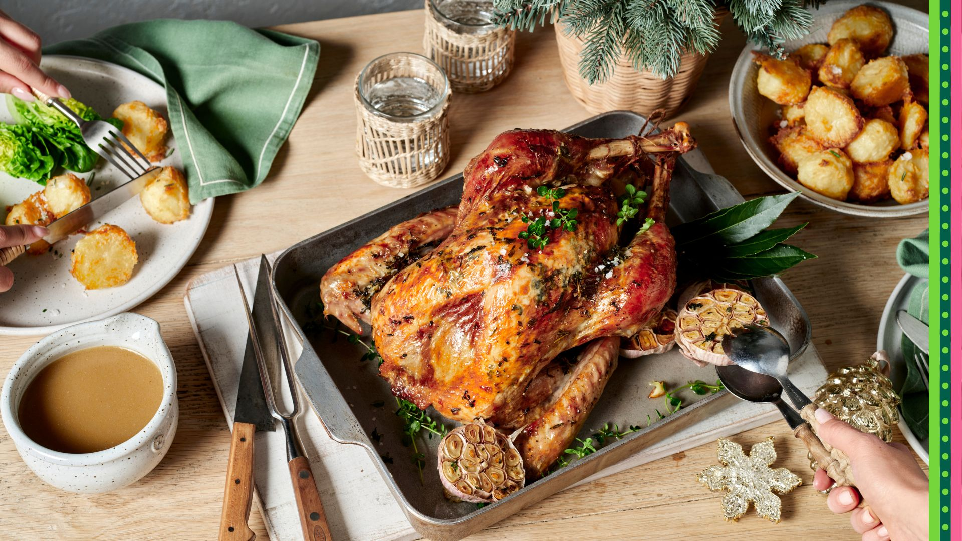Golden roast turkey with a side of baked potatoes and gravy, ready to be served