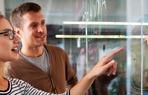 Colleagues working and brainstorming in office