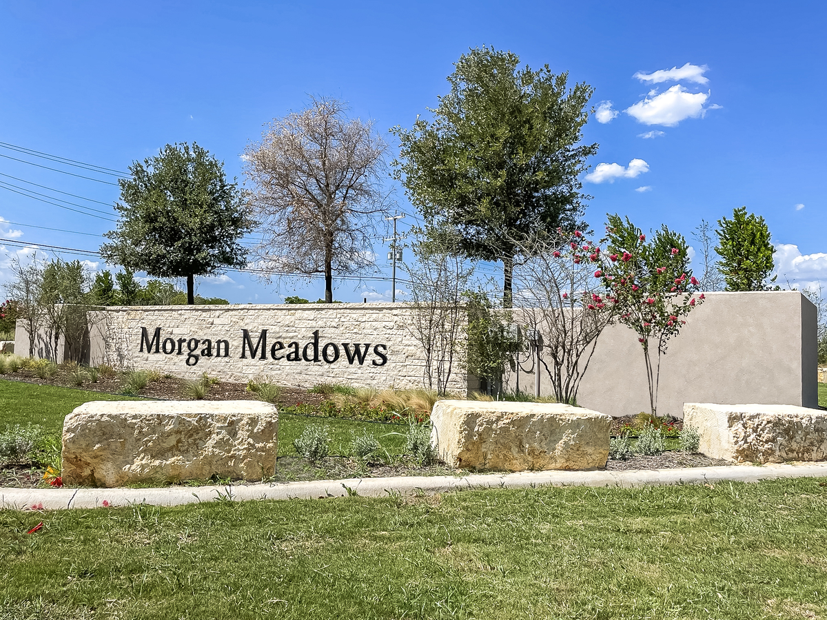 entrance with a stone sign & trees