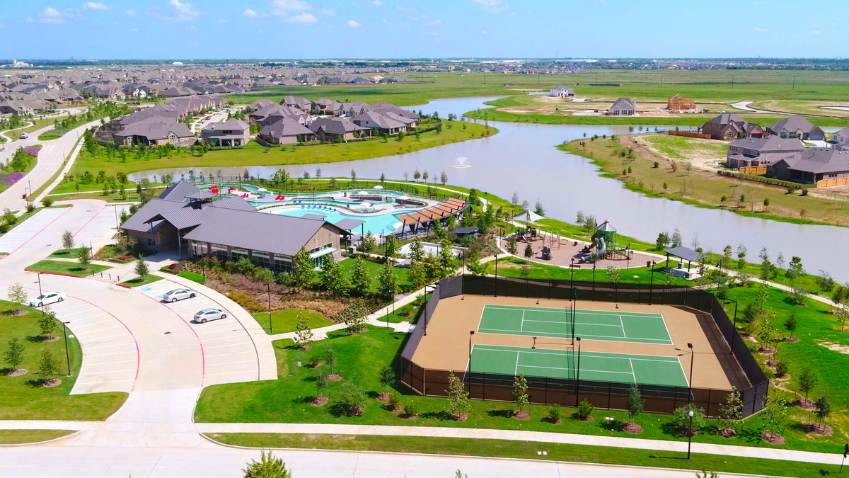 ariel view of tennis courts and community pool 