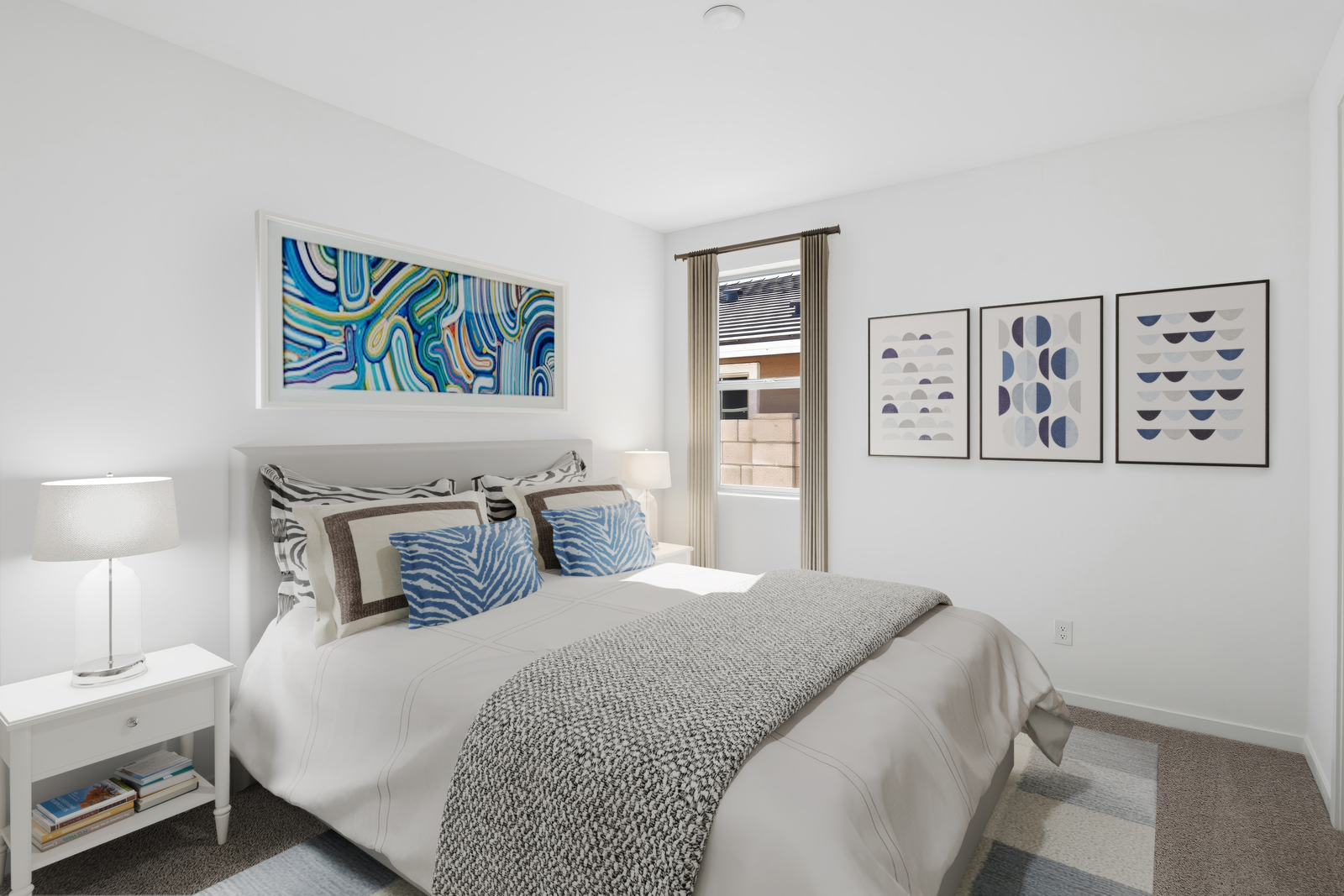 bedroom with a large bed, blue accent colors, and white nightstands