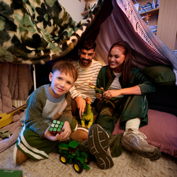 Family playing under loungeroom fort