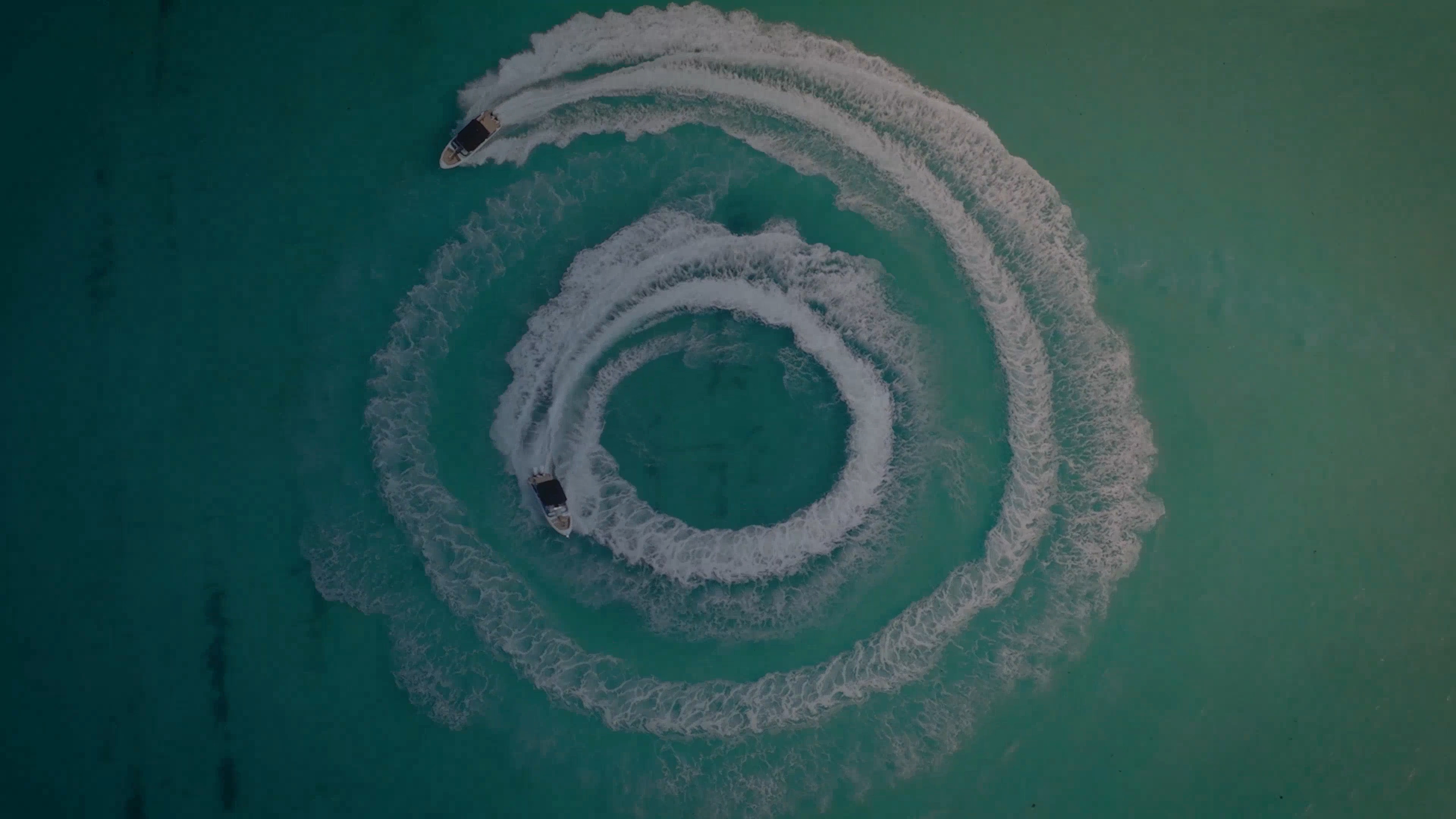 Two boats sailing in circles