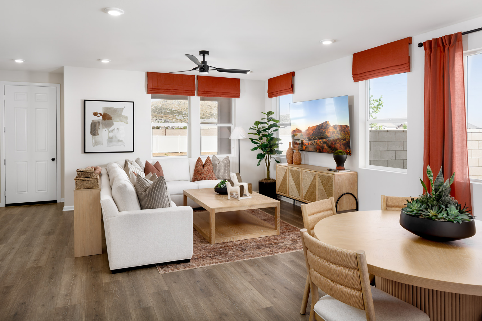 great room with large windows and neutral floors