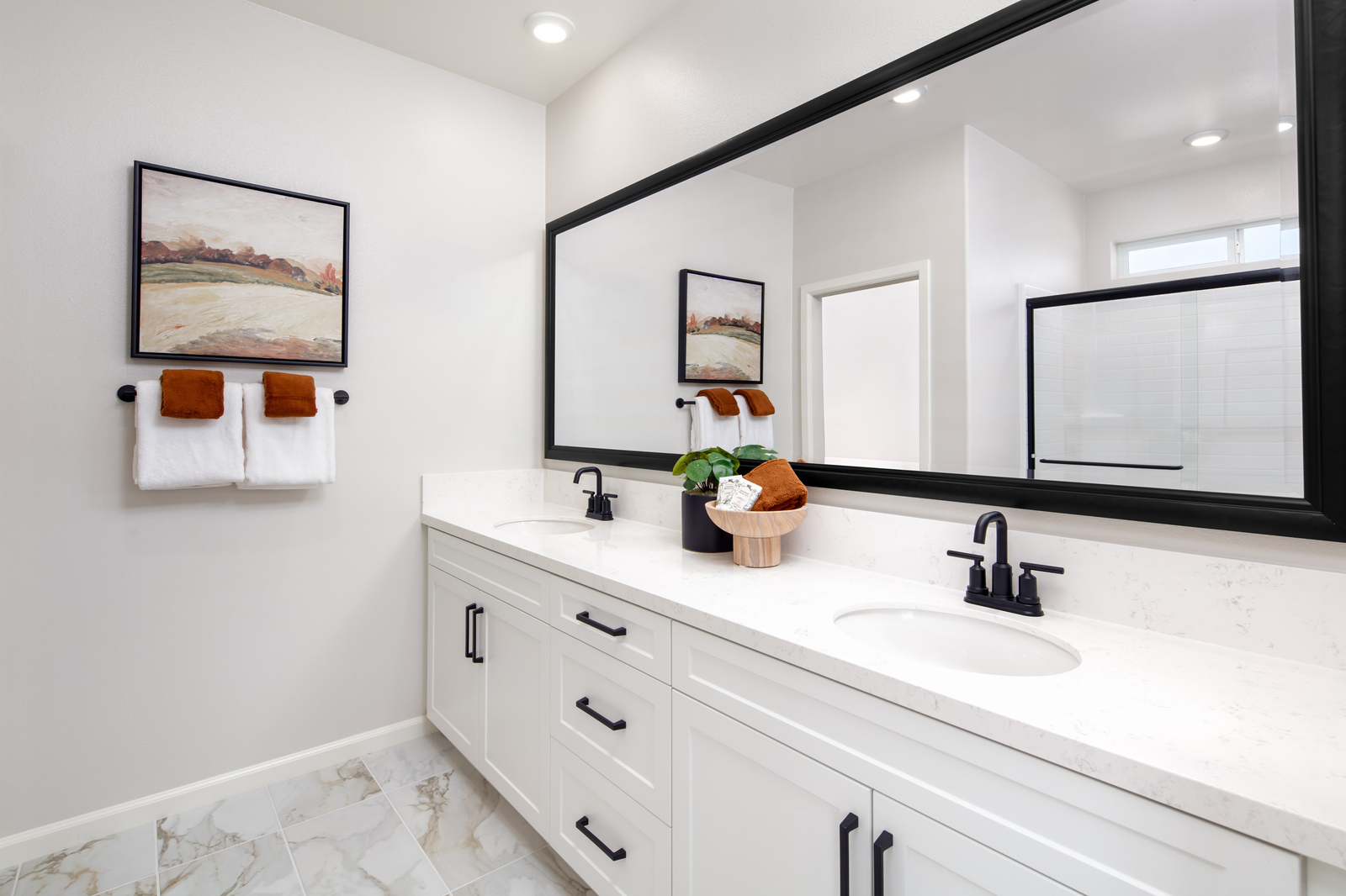 primary bathroom with white countertops and cabinets