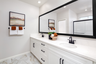 primary bathroom with white countertops and cabinets