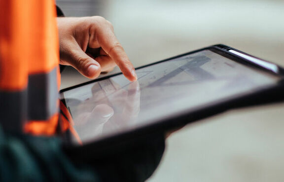 Construction worker using a tablet at a work site
