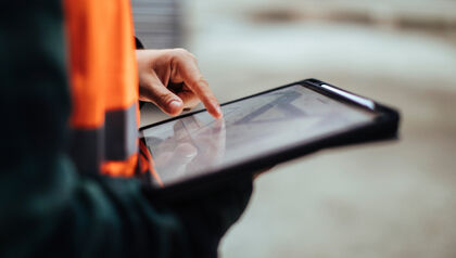 Construction worker using a tablet at a work site